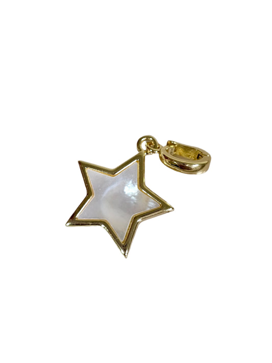 Gold star-shaped pendant on a marble surface
