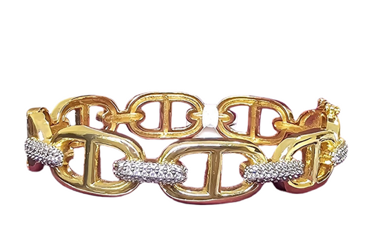 Gold bracelet with diamond accents on a white background