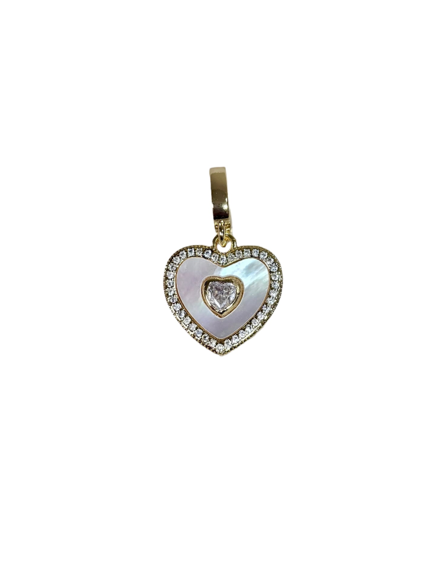 Heart-shaped pendant with a central diamond on a marble surface