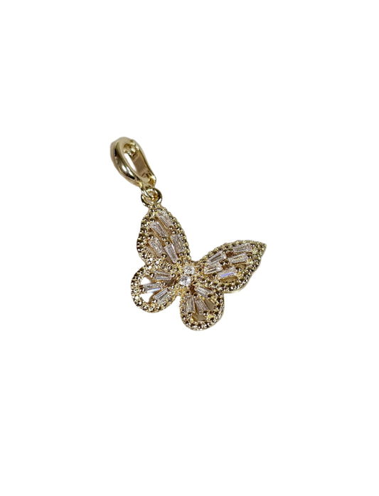 Gold butterfly pendant on a marble surface