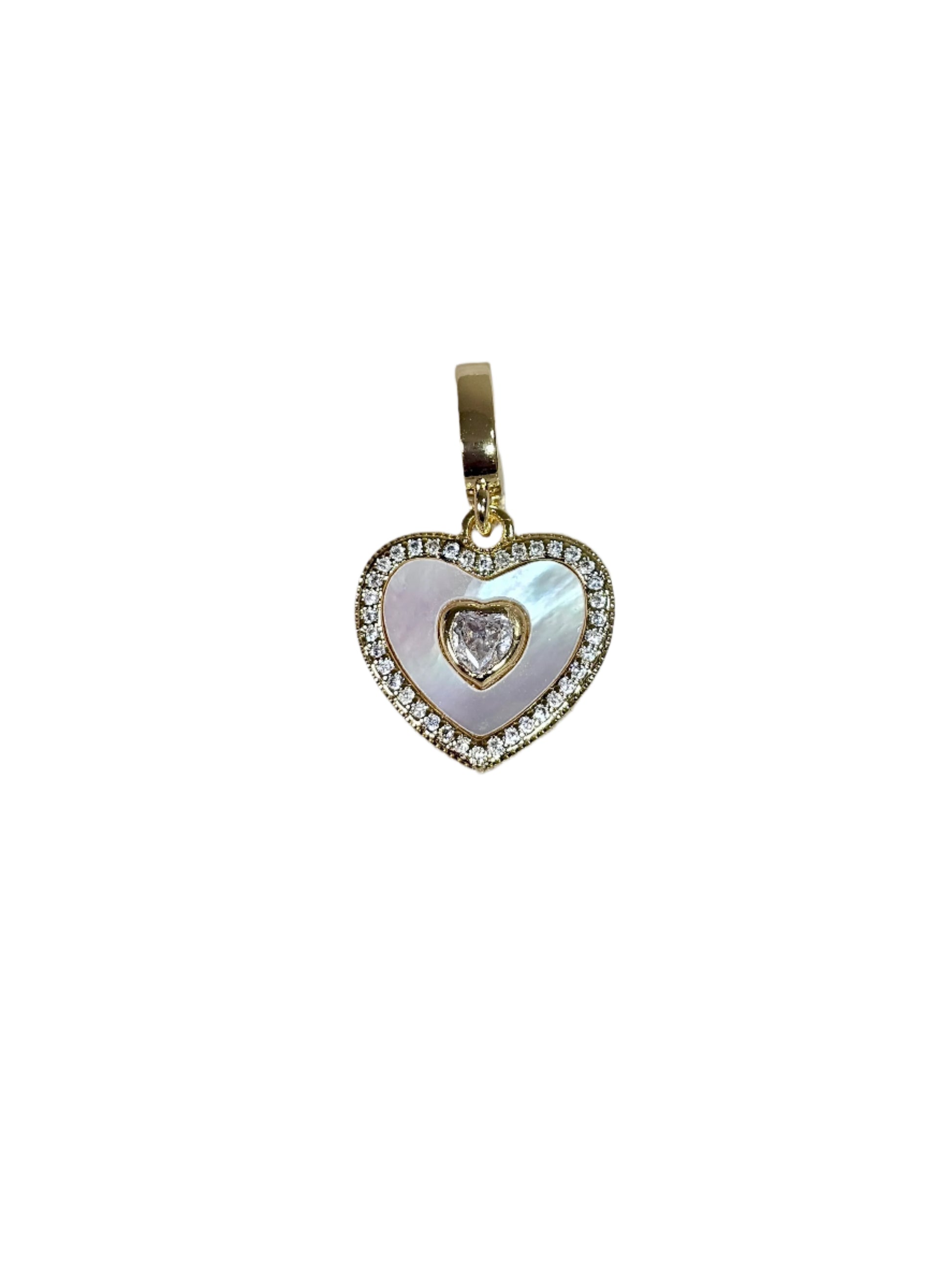 Heart-shaped pendant with a central diamond on a marble surface